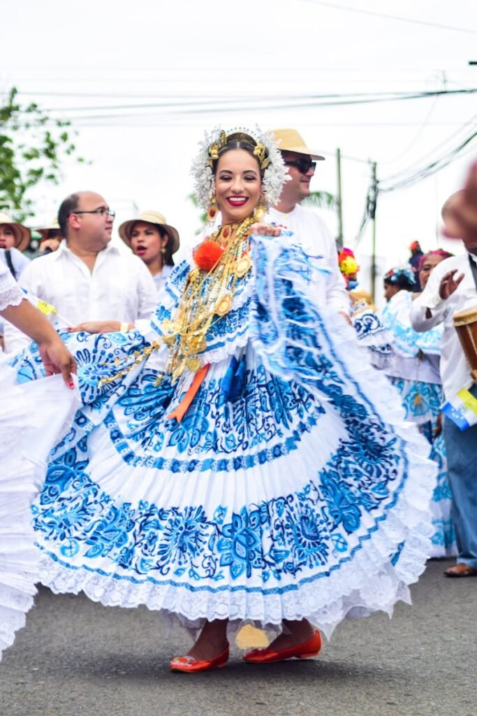 Festive dancers in vibrant traditional attire at a Panamanian parade celebration outdoors.